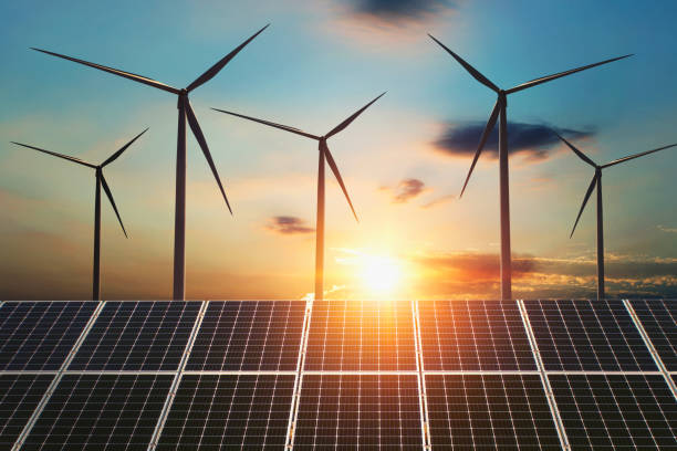 istock concept clean energy. wind turbine and solar panel in sunrise background 1127283509