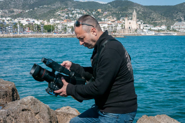 istock Cameraman recording outdoors while recording a music video clip 1127283658