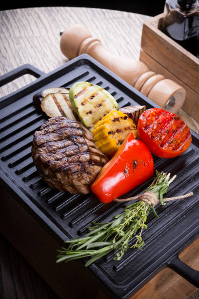 istock Cooked beef steak on a metal electric grill 1127284776