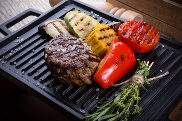 istock Cooked beef steak on a metal electric grill 1127284809