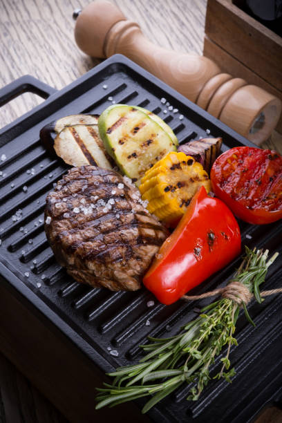 istock Cooked beef steak on a metal electric grill 1127284814