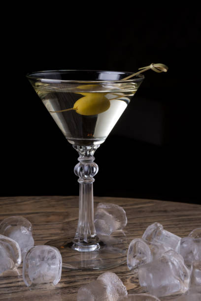 Martini glass with olive on a bar counter