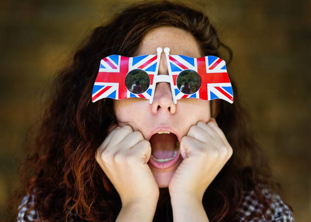 istock Young woman in Union Jack sunglasses is horrified 1127284896
