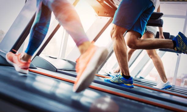 istock Group of friends exercising on treadmill machine 1127285115