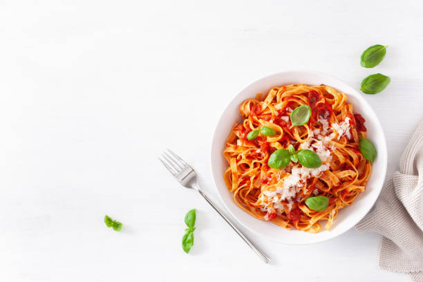 tagliatelle pasta with tomato sauce parmesan basil stock photo
