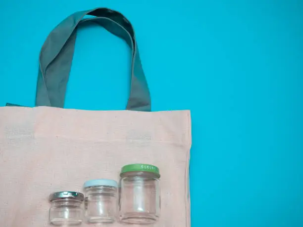 Photo of few empty glass jars on fabric bag