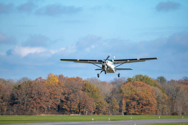 istock Single prop airplane taking off from the runway in autumn sunlight 1127290741