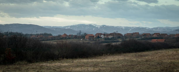 Winter rural scene at sunset with bits of snow