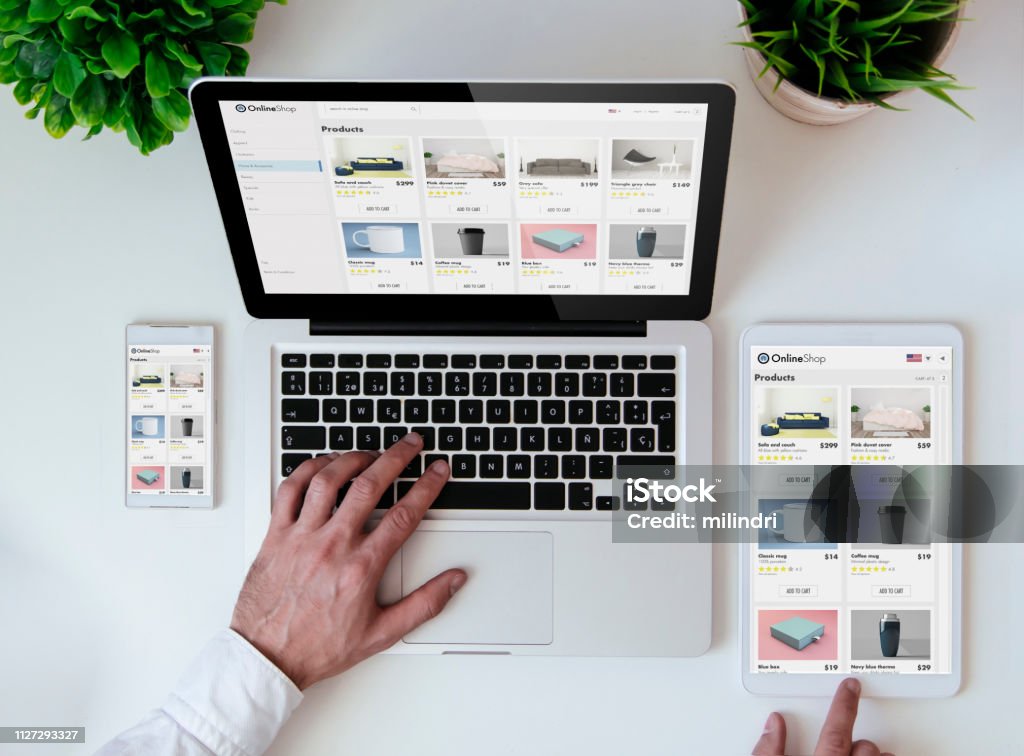 office tabletop online shopresponsive design website office tabletop with tablet, smartphone and laptop showing online shop responsive design website E-commerce Stock Photo