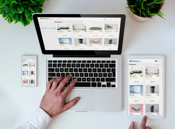 office tabletop with tablet, smartphone and laptop showing online shop responsive design website