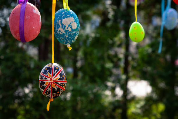 istock Happy Easter card. Colorful handmade Easter eggs decorated city streets and parks. 1127293954