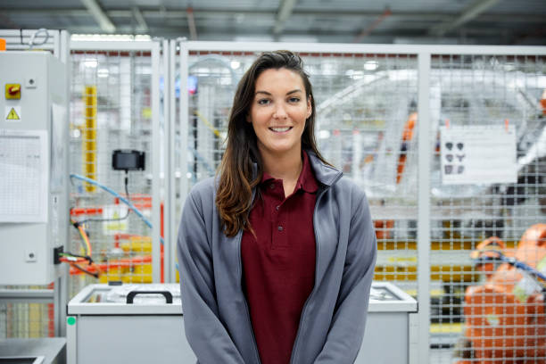 istock Smiling female engineer in automobile industry 1127294296
