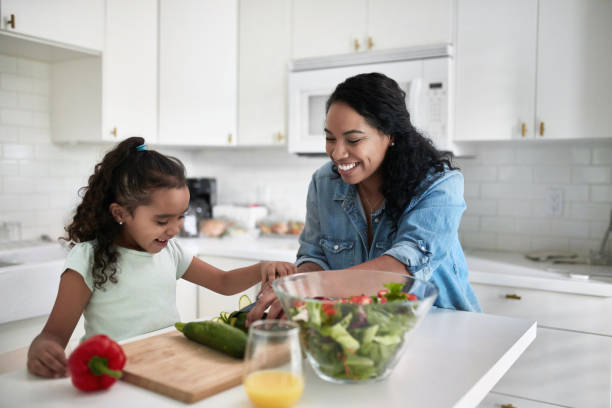 istock Girl learning to cut zucchini from mother 1127294749
