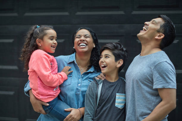 istock Happy family standing against wall during weekend 1127295774