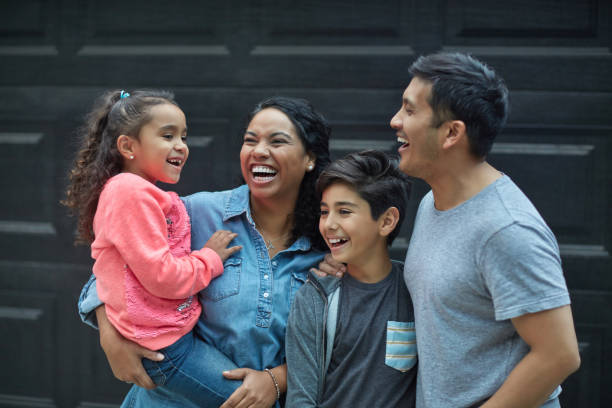 istock Cheerful multi-ethnic family against wall 1127295778