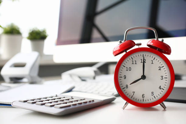 istock Red alarm clock set at eight in the morning closeup 1127296502
