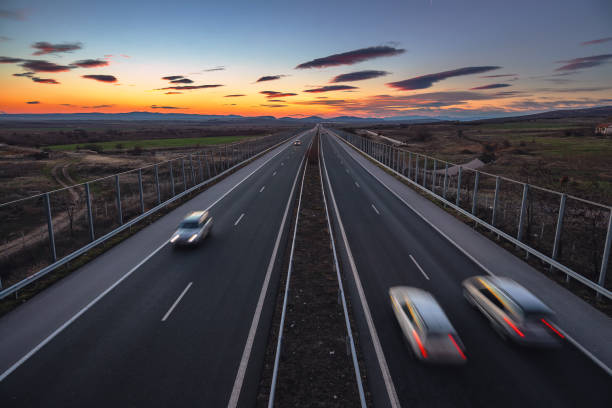 istock Aerial view of highway and beautiful sunset cloudscape 1127296504
