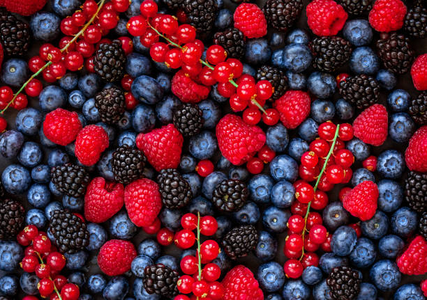 istock Berries overhead Background. Fresh Summer Berry mix with Strawberry, Raspberry, Red currant,  Blueberry and Blackberry, top view 1127297578