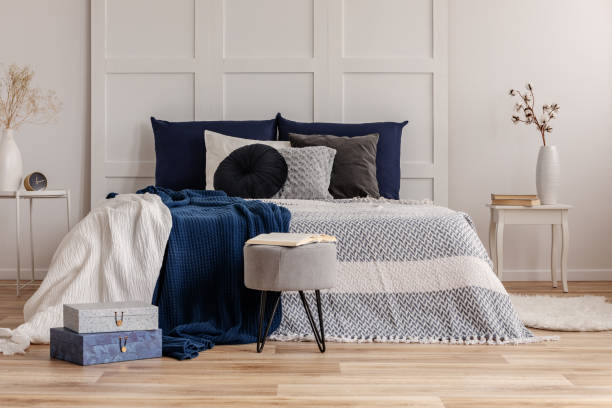 istock Grey and blue bedding and blanket on comfortable king size bed 1127298975