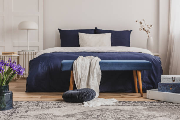 istock White pillow on blue bedding on king size bed in fashionable bedroom interior 1127298976