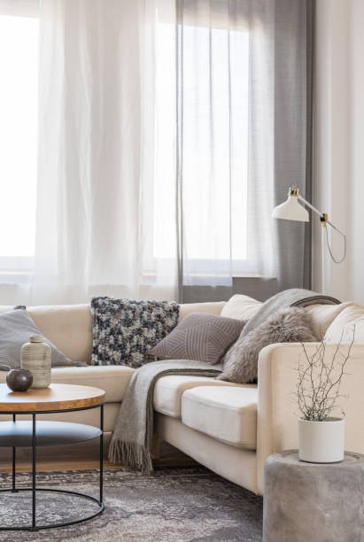 istock Pillows and blanket on comfortable couch in trendy living room 1127300768