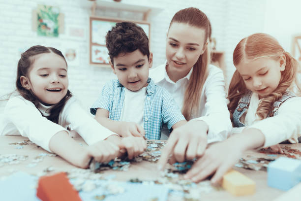 istock Children in Kindergarten put puzzle together. 1127301112