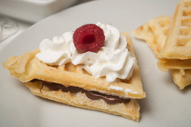 istock waffle in shaped heart with chantilly cream and raspberry in a white plate 1127301339