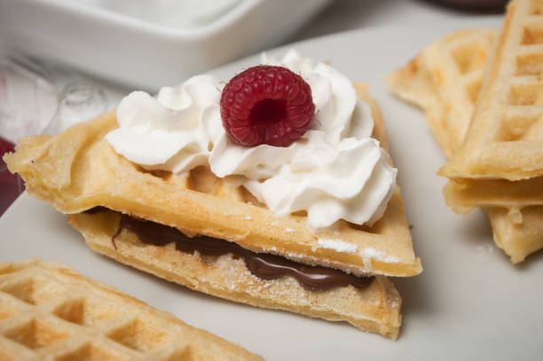 istock waffle in shaped heart with chantilly cream and raspberry in a white plate 1127301651