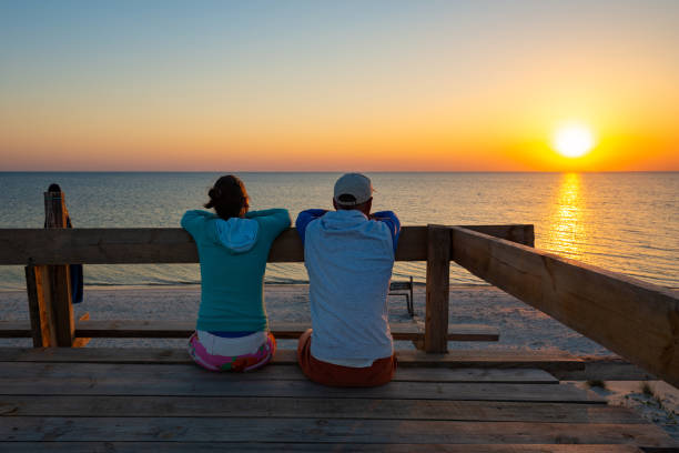 istock Happy couple relaxes on a bungalow veranda 1127302400