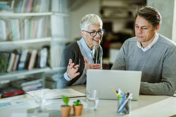 istock Business colleagues cooperating while working on laptop in the office. 1127302409