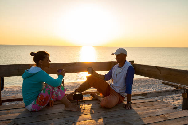 istock Romantic couple relaxes on a old wooden bungalow veranda 1127302421