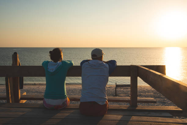 istock Happy couple relaxes on a bungalow veranda 1127302499