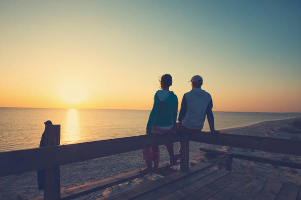 istock Happy couple relaxes on a bungalow veranda 1127302509