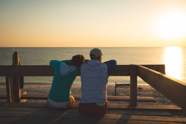 istock Happy couple relaxes on a bungalow veranda 1127302512