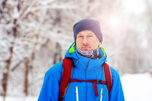 istock Happy man, traveler walking in the winter forest during snowfall 1127302926