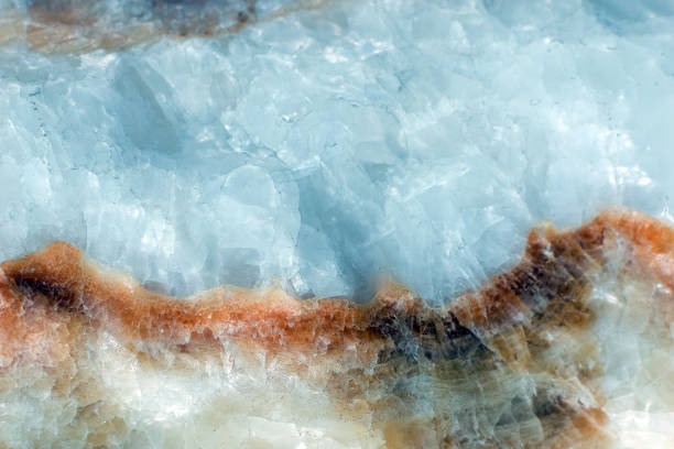 Horizontal lightened slices of blue marble quartz ice background. with brown stripe Cold calm colors icy background ideal for your design