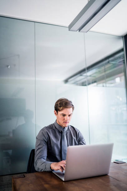 istock Confident businessman using laptop in board room 1127303237