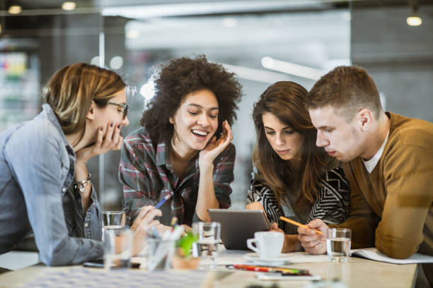 istock Team of young freelancers using digital tablet in the office. 1127304254