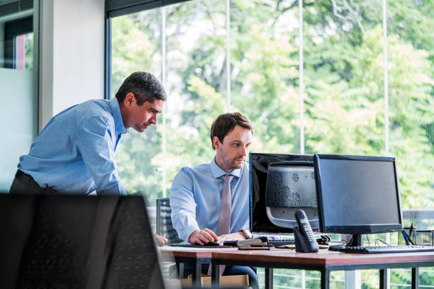 istock Business people working on office desk by window 1127304937