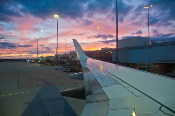 istock Peaceful twilight evening scene in the airport with a white plane wing 1127305036