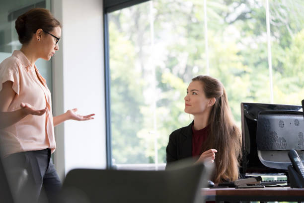istock Businesswoman gesturing while talking to colleague 1127305091