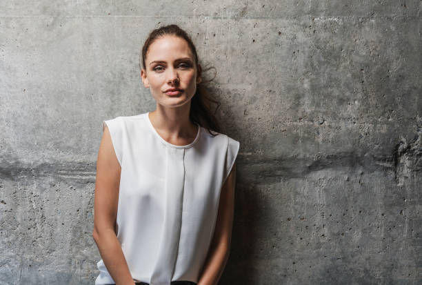 istock Confident woman leaning on wall 1127306267