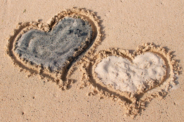 istock Two heart shapes in the sand 1127306643