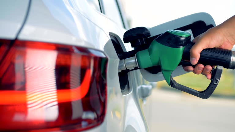 Gas nozzle is getting taken out from car's fuel tank