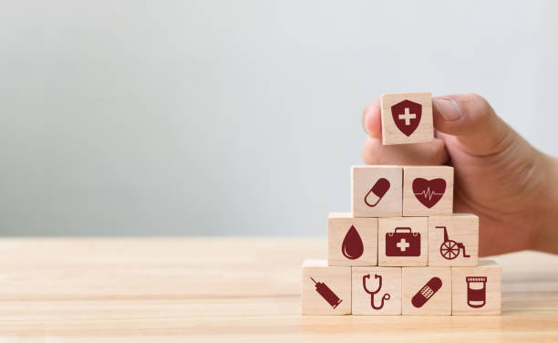 Hand arranging wood block stacking with icon healthcare medical, Insurance for your health concept Hand arranging wood block stacking with icon healthcare medical, Insurance for your health concept patient blood management stock pictures, royalty-free photos & images