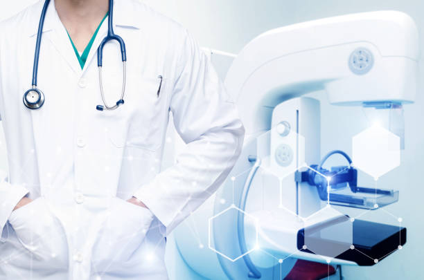 istock smart man doctor with stethoscope around his neck with technology digital network effect and Mammography X-Ray System Machine in hospital background, medical innovation, future technology concept 1127307440