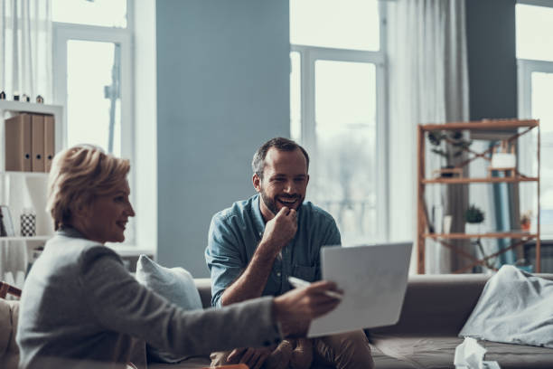 istock Emotional man laughing while psychotherapist showing him pictures 1127307729