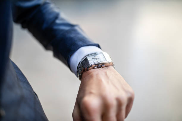 бизнесмен смотрит на эти часы - checking the time urgency watch business стоковые фото и изображения