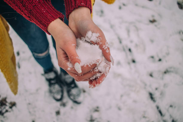 istock Girl holding snow 1127311723