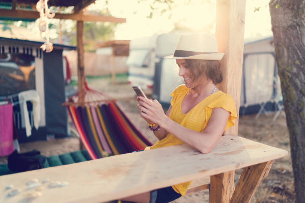 istock Young woman on beach holiday texting 1127313040